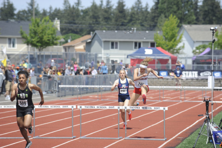 Camas High freshman Lucy George (right) in the 100-meter hurdles.