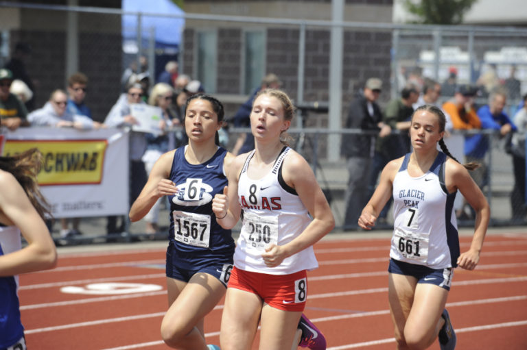 Camas High School senior Ellie Postma (center) pushes hard in the final race of her high school career.