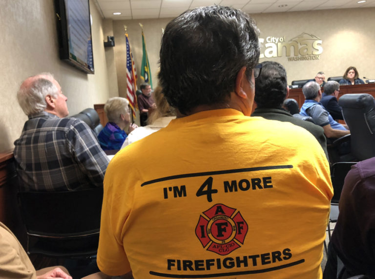 Camas-Washougal Fire Department Battalion Chief Larry Larimer wears a yellow &quot;I&#039;m 4 More Firefighters&quot; T-shirt to a June 4 Camas City Council meeting, where he and several other firefighters spoke about a recent state report that found the city of Camas in violation of breaking firefighter safety laws and urged higher staffing levels at the local fire department.