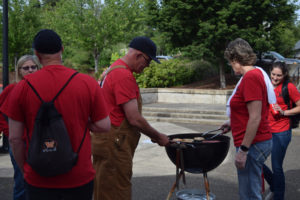 Washougal School District teachers sport their red Washougal Association of Educators shirts during a tailgate to kick off negotiations between the union and the Washougal School district, May 30.