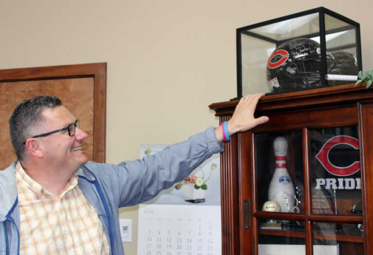 Camas Mayor Scott Higgins admires Camas High School memorabilia on display in his office.