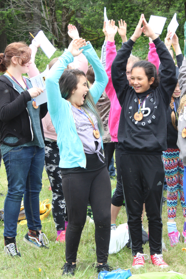 At right, Canyon Creek Middle School students Jordan Berry (front, center) and Leila Tienhaara (front, right) pretend to be seedlings growing into trees during a group exercise at a Friends of the Gorge &quot;Explore the Gorge&quot; outdoor school, held at Beacon Rock in the Columbia River Gorge National Scenic Area on June 14.