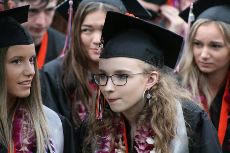 Raindrops cover Washougal graduate Kate Northcut&#039;s glasses as she listens to her classmates recall special memories over the past 12 years of school.