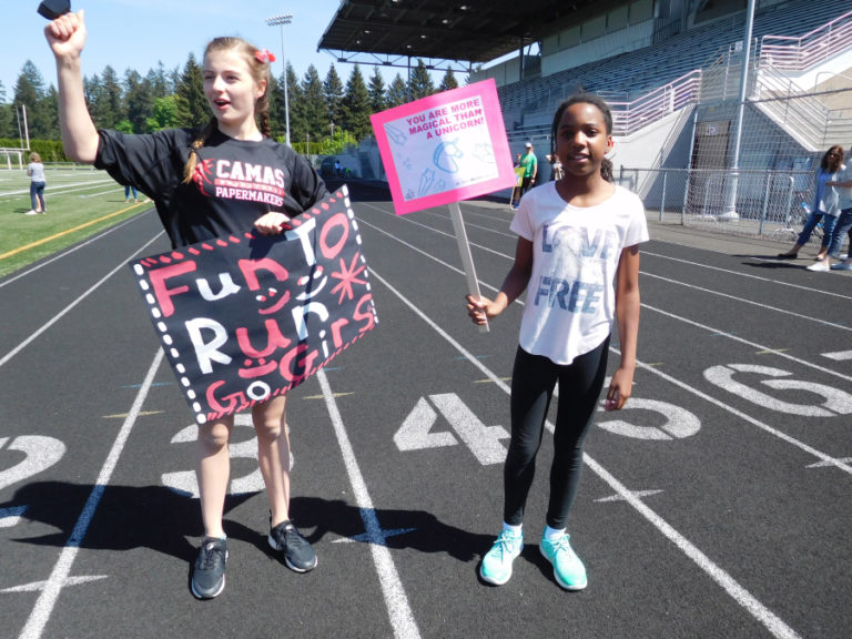 Students from Liberty Middle School provide encouragement as Helen Baller Elementary School students practice to run a 5K at Doc Harris Stadium, in Camas.