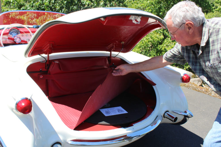 Steve Chaney shows where the spare tire goes inside the trunk of his classic, award-winning 1954 Chevy Corvette.