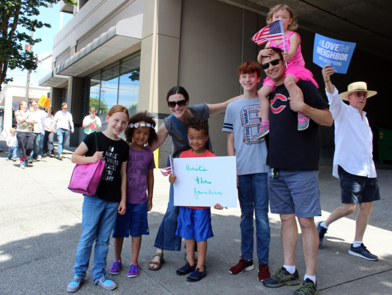 Ken Mach (second from right in black Camas shirt), of Camas, attends the June 30 Families Belong Together march in downtown Vancouver with his wife, Chelsey (third from left) and their five children (from left to right): Matayah, Oliver, Asher, Parker and Hazel (on Ken&#039;s shoulders).