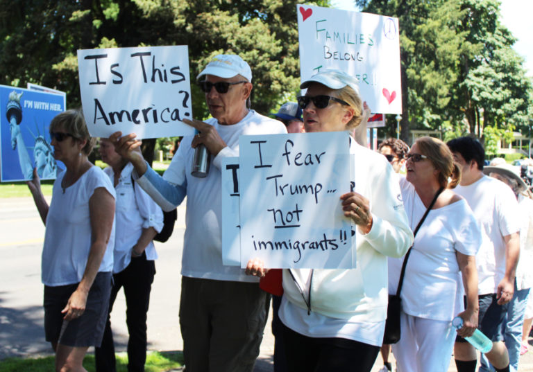Frank Pinelli (third from left) and Joanne Pinelli (fourth from left) carry &quot;Is This America?&quot; and &quot;I fear Trump not immigrants!&quot; signs during a June 30 Families Belong Together march through downtown Vancouver in support of immigrants and in protest of the Trump administration&#039;s recent immigration deterrent tactics. More than 500 participated in the Vancouver march, one of more than 600 that took place Saturday in all 50 states.