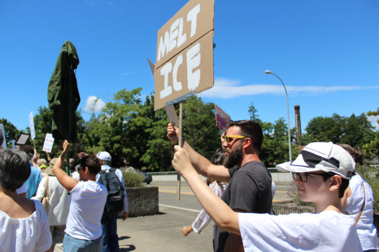 Participants in the Families Belong Together march cross the Interstate 5 overpass in downtown Vancouver on Saturday, June 30.