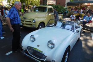 Area residents view pickup trucks and sports cars during the Camas Car Show, Saturday, July 7, in downtown Camas. Marc Luce, of Camas, won "Best in Show" for his 1936 Ford Cabriolet (not pictured), and John Zoller, of Vancouver, received the "People's Choice" award for his 1967 Ford Mustang (not pictured). 