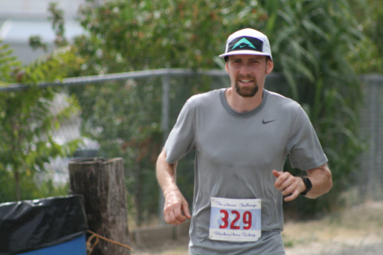 Casey Kemp runs along the Columbia River Dike Trail on his way to winning The Heroes&#039; Challenge 10K.