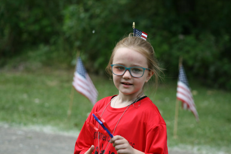 Chanel Hoy, 8, cools off with the stars and stripes after running her first ever race.