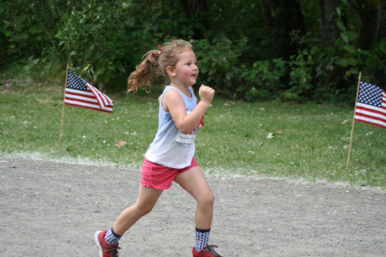 Nika Magner, 4, is all smiles as she crosses the finish line at The Heroes&#039; Challenge at Capt. William Clark Regional Park, in Washougal.