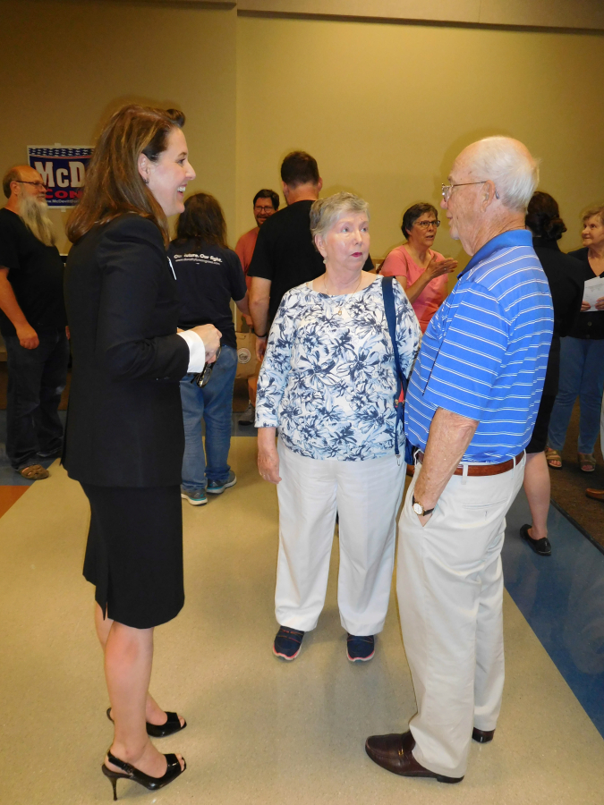 Carolyn Long (left), a Democratic candidate for the 3rd Congressional District, talks with area residents after a League of Women Voters of Clark County forum, July 12, at Clark College, in Vancouver.