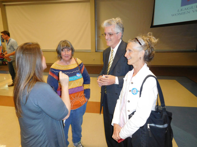 David McDevitt (second from right), a Democratic candidate for the 3rd Congressional District, and his partner, Sally Hart (right), talk with attendees after a League of Women Voters of Clark County forum, July 12, at Clark College, in Vancouver.