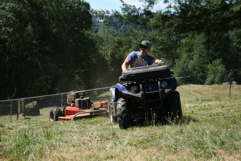 Braden Devlin helps mow the grounds at the Washougal Motocross Park in preparation for the Lucas Oil Pro Motocross Nationals, which are expected to attract more than 20,000 race fans to Washougal on Saturday, July 28.