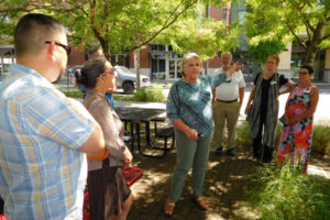 Washougal Mayor Molly Coston (center) talks about downtown Washougal from Reflection Plaza, July 13, during the Columbia River Economic Development Council's Main Street Day. Tour participants also visited downtown Camas, Vancouver, Ridgefield, La Center and Battle Ground. 