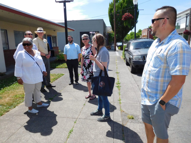 Heena Dwivedy (left), president of the Downtown Washougal Association, leads officials from throughout Clark County down Main Street in downtown Washougal, July 13.