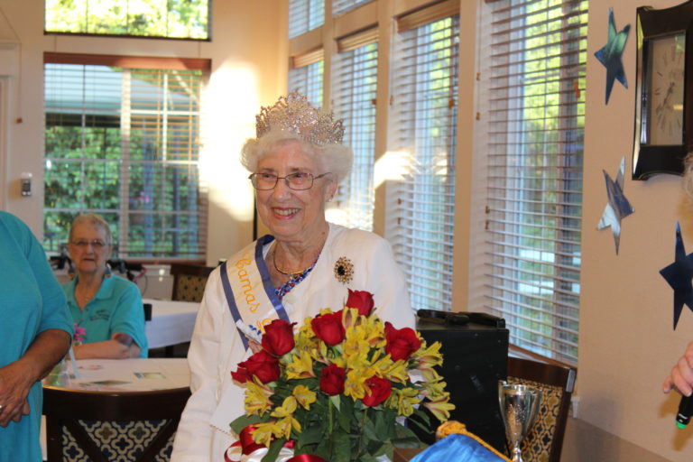 2018 Camas Days Queen Maxine Ambrose accepts her crown, sash and flowers at a queen's coronation held July 18, at the Columbia Ridge Senior Living center in Washougal. 
