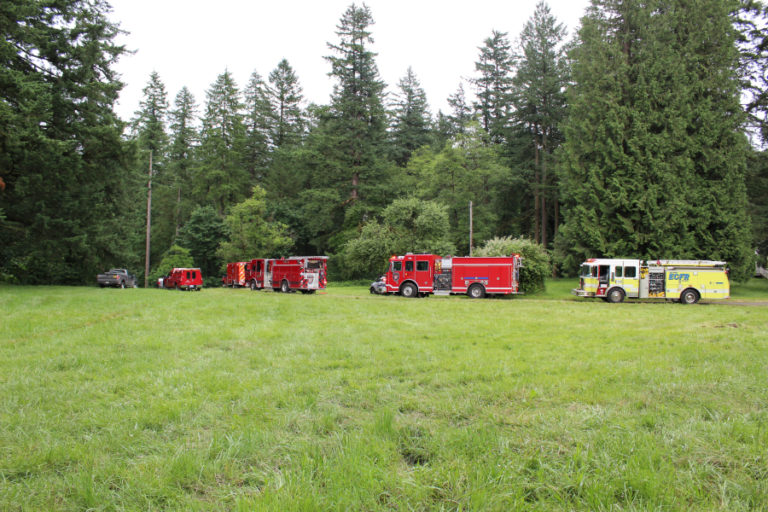 Rescue crews line up at an access point to retrieve the body of a woman who died inside the Lacamas Park &quot;potholes&quot; in June 2017.
