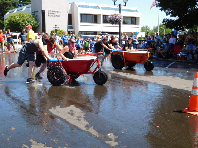 The “Bathtub Bandits” (left) compete against Hidden River Roasters in the Camas Days bathtub races Saturday, July 28. The Bandits won first place out of 10 teams.
