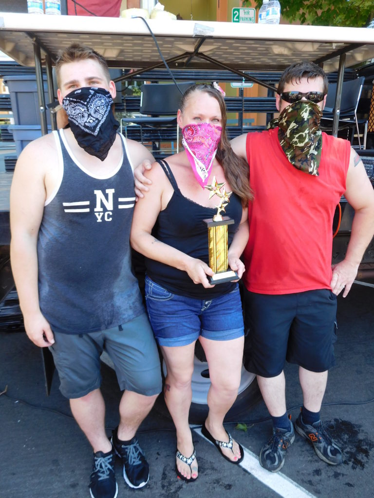 The "Bathtub Bandits," consisting of Triston Groth (left) and his parents, Tanya Groth and Greg Irwin, win first place in the Camas Days bathtub race competition Saturday, July 28. The team has earned third place or better for 13 years.

