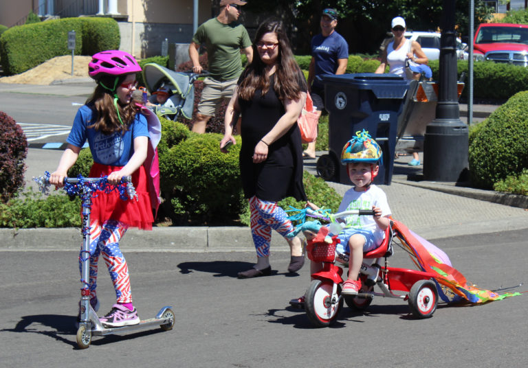 Children ride decked-out scooters and bikes during the2018 Camas Days Kids Parade on Friday, July 27, in downtown Camas.