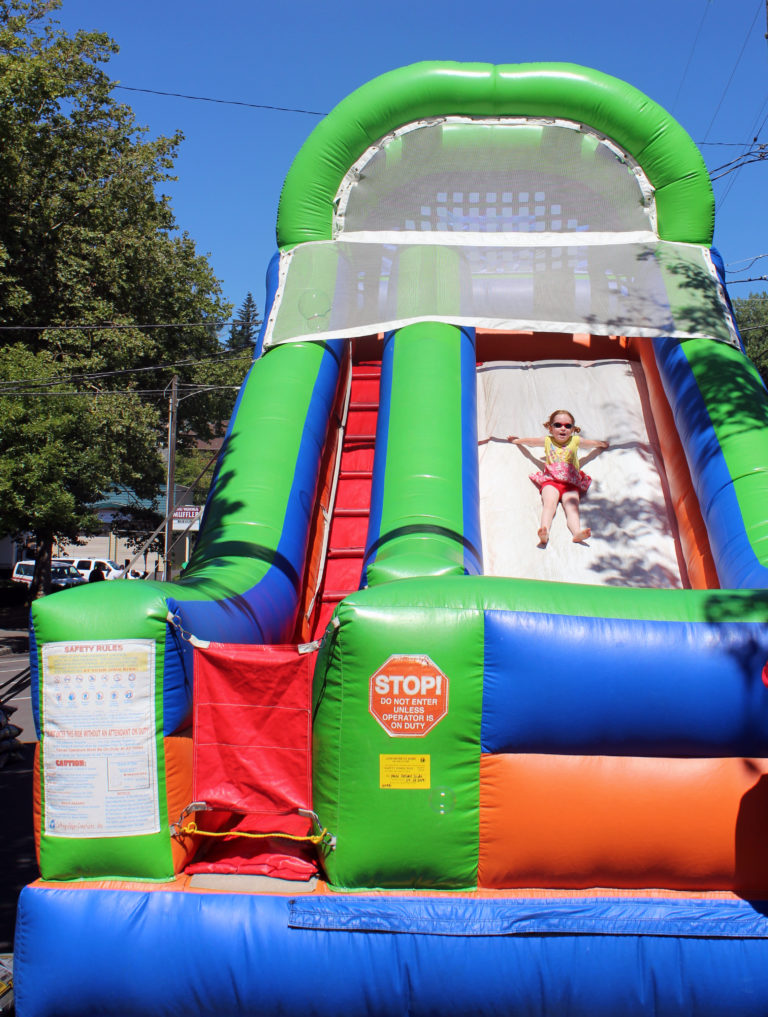 A child slides down a giant bouncy slide at the Camas Days Kids' Street, at Northeast Dallas Street and Northeast Fourth Avenue in downtown Camas on Friday, July 27 during the 2018 Camas Days event.