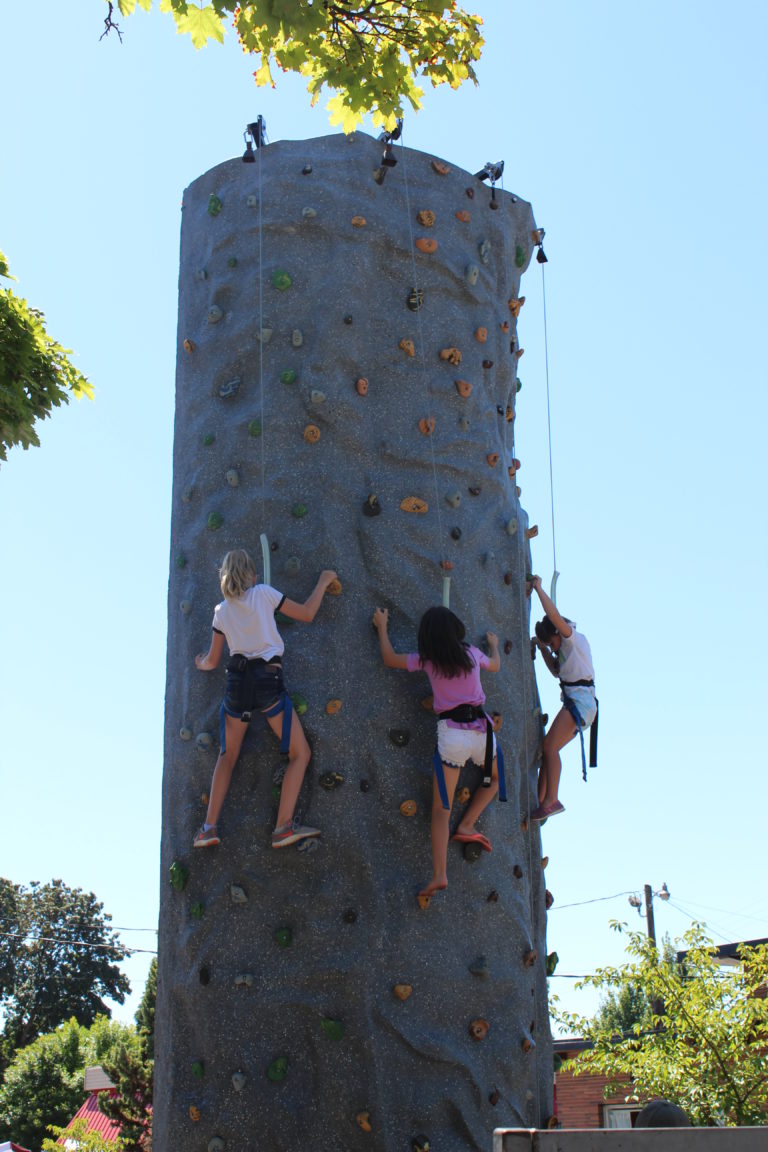 Children climb a giant rock wall off Northeast Fourth Avenue in historic downtown Camas on Friday, July 27 during the first day of the annual Camas Days festival.