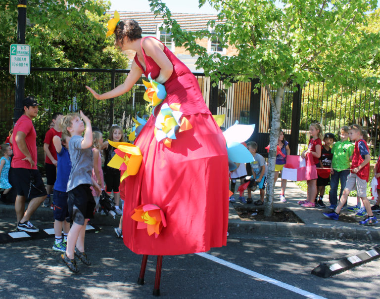 A stiltwalker gives high fives before the 2018 Camas Days Kids Parade in downtown Camas on Friday, July 27.