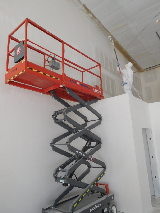 Jose Chavez, with Oswego Drywall Installers, Inc., of Tualatin, Oregon, applies primer to a wall inside the future site of Sunbridge Solar, in Washougal. The solar panel installation company is currently located in Vancouver.