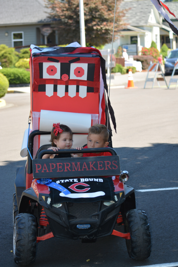Harper Copsey, 1, and Jameson Douglas, 4, won first place in the non-motorized floats, bikes and wagons contest for their Papermakers Mean Machine float.