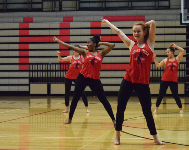 Camas High dance team members liven up their routine with excited faces during practice on Saturday, August 4.