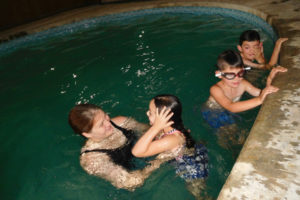 Kathi Sjostrom, a former recreation coordinator and pool manager for the city of Camas, teaches 5-year-old Ella Eckman (left), 6-year-old Dane Hutton (center) and Thomas Eckman, 7 (right), in a semi-private swim class at her Camas home. Sjostrom opened Just Add Water Swim School this summer.