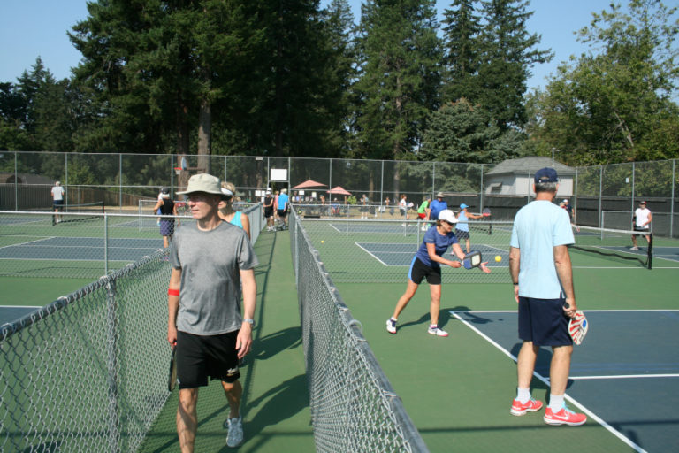 Pickleball players rotate courts after each game at Hathaway Park in Washougal. The sport has exploded in popularity in recent years and was invented in the 1960s by a former Washington state Lt.