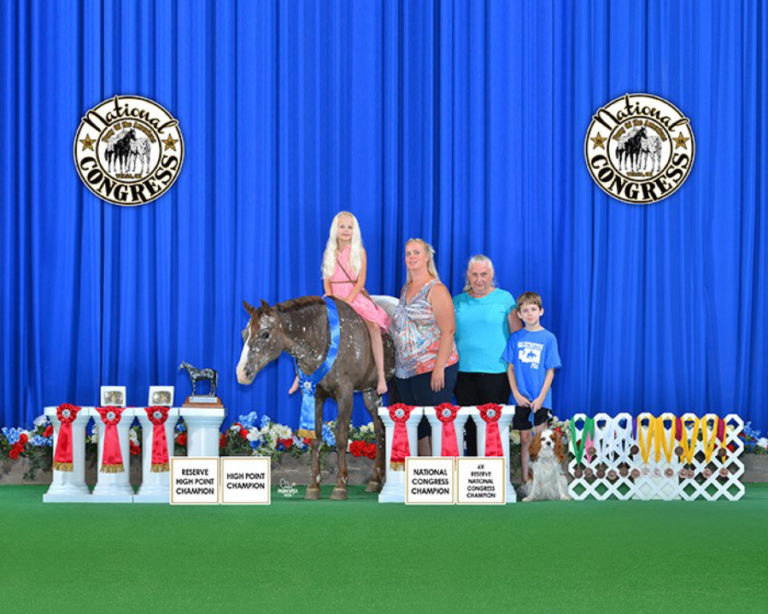 Aubrie Wheeler from Camas recieves her first place all around trophy with her family at the National Congress show in Tulsa, Oklahoma.