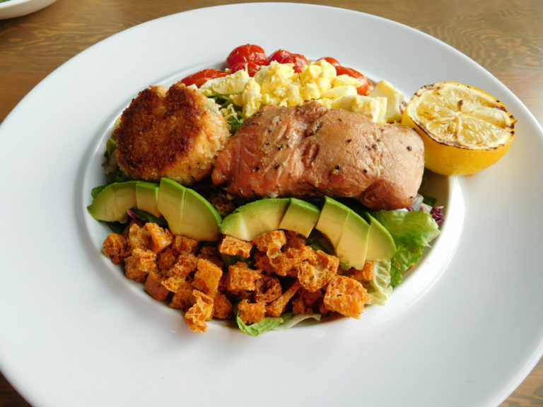 The Pacific cobb salad at The Hammond Kitchen + Craft Bar, in Camas, includes smoked salmon, a crab cake, roasted tomatoes, chopped egg, avocado, croutons and green goddess dressing.