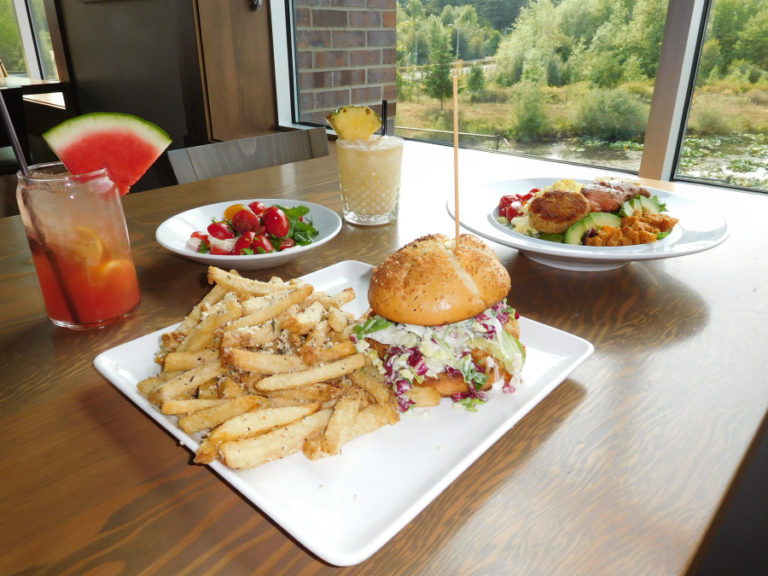 Menu options at The Hammond Kitchen + Craft Bar, in Camas, include (clockwise from front): a buttermilk fried chicken sandwich, the &quot;Hammond Sangria,&quot; organic tomato and arugula salad, &quot;Killer Coco&quot; and Pacific cobb salad with smoked salmon.