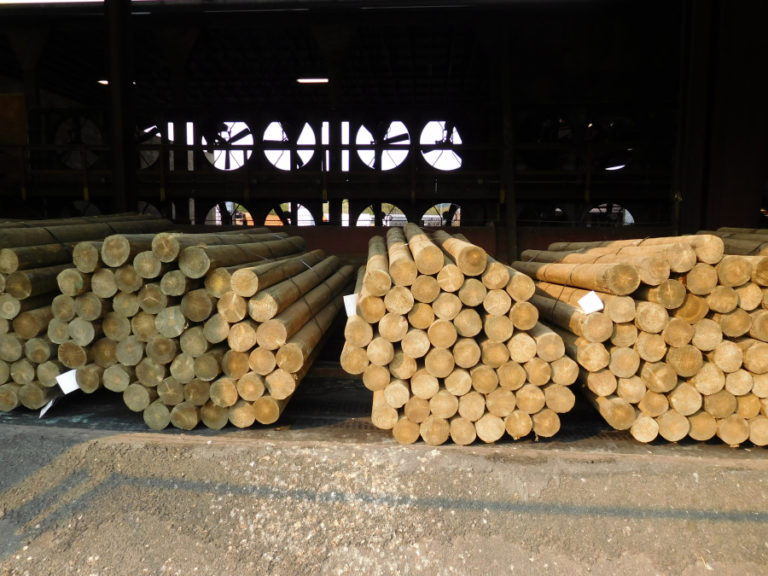 Round wood fence posts, stacked at Exterior Wood, Inc., in Washougal, will be pressure treated and sold to retail building supply centers throughout the Western United States and Canada.