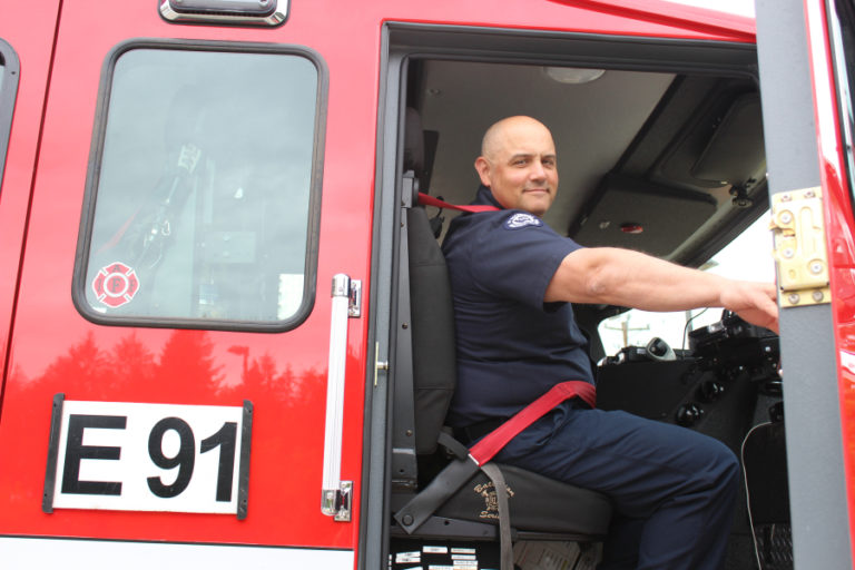East County Fire and Rescue Fire Captain James Troutman looks down from the front seat of Station 91's fire engine on Friday, Aug. 24.