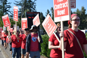 Washougal High School teachers walk the picket line after the teachers union and district failed to reach a tentative collective bargaining agreement before the scheduled start of the school year, Tuesday, Aug. 28. 