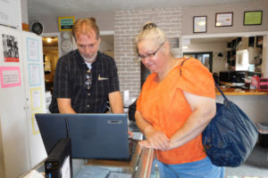 David Lamb Sr., co-owner of Silver Star Computers and Solutions, in Washougal, helps customer Kathleen Washenberger with a laptop computer issue. 