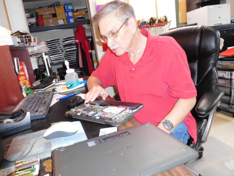 Ken Huckaby, co-owner of Silver Star Computers and Solutions, in Washougal, orders a battery for a laptop computer.