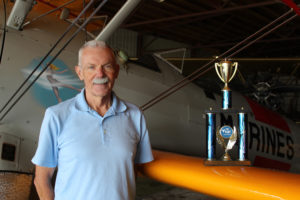 Camas-Washougal Aviation Association President Kent Mehrer stands inside his Camas home-based hangar on Aug. 24, next to the "Sponsor's Choice" trophy he won at the 2017 Wheels and Wings car and plane show, held at the Port of Camas-Washougal's Grove Field Airport in Camas.