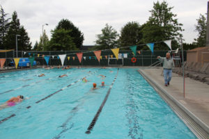 Above: Coach Mike Bemis instructs girls from the Camas and Washougal high school swim teams during an early morning practice Aug. 24.  Both swim teams will compete at a regional meet at 4 p.m., Wednesday, Sept. 12, at Cascade Athletic Club, 16096 S.E. 15th St., Vancouver, against swimmers from Evergreen, Heritage, Union and Mountain View high schools. 