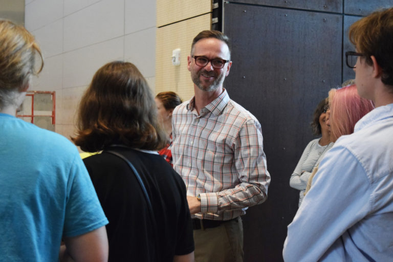 Aaron Smith, principal of Discovery High School and Odyssey Middle School, chats with students and family members as they view the inside of the new project-based learning high school during an Aug. 30 orientation.