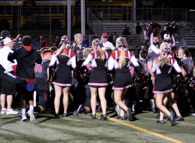 Camas High cheerleaders and fans rush the field at Doc Harris Stadium, Sept. 7, after a 52-0 win against Hazen High.