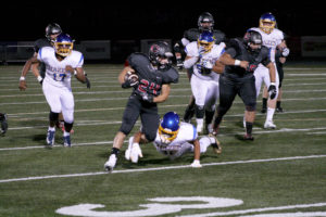 Camas running back Randy Yaacoub busts through the line on his way to one of three touchdowns during the Papermakers' home opener against Hazen, Friday, Sept. 7. 