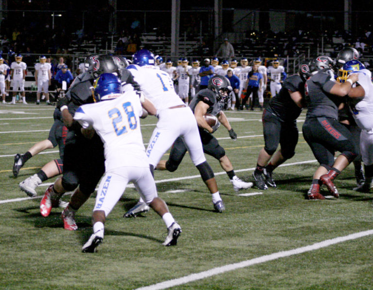 The Camas High Papermakers&#039; Randy Yaacoub goes up the middle for one of his three touchdowns.