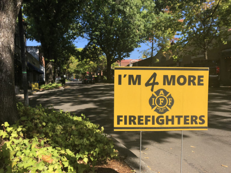 Signs supporting &quot;more firefighters&quot; at the Camas-Washougal Fire Department are displayed throughout the city of Camas, including the one shown here on Northeast Fourth Avenue near the Camas Hotel.