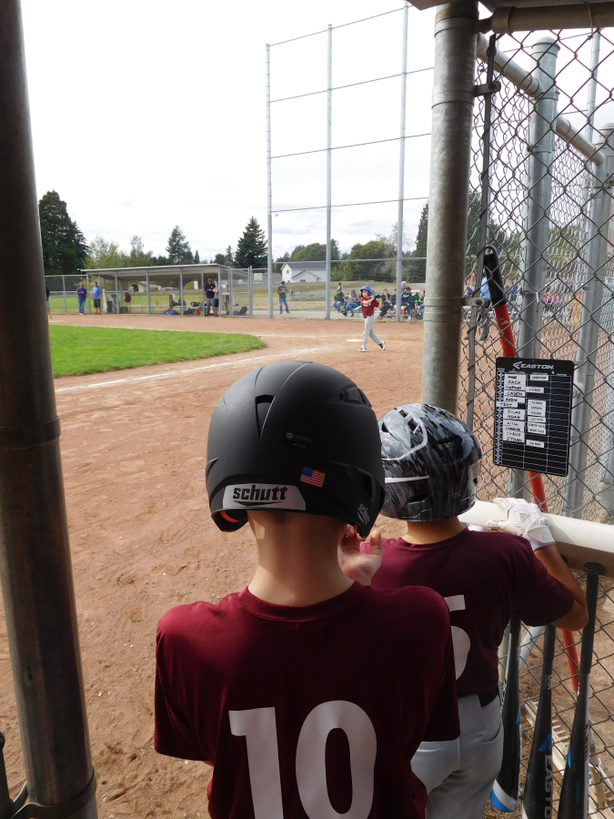 East County Little League Squirrels, of Washougal, await their turn in the dugout to bat in a game with the Cascade Little League Yankees, of Vancouver, Saturday, Sept.